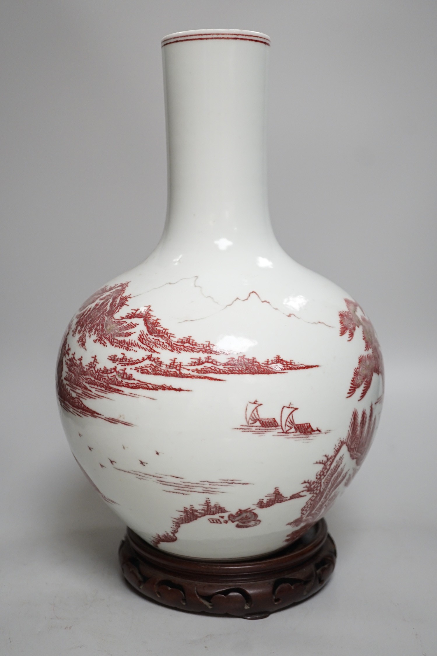 A large Chinese underglaze copper read landscape vase on hardwood stand, 40cm total